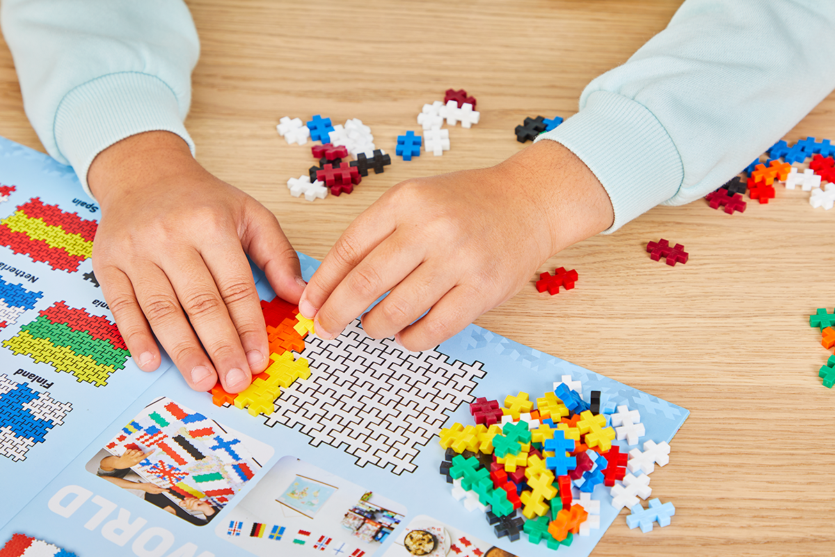 Zawartość zestawu PLUS-PLUS Flagi z całego świata 700e rozłożona na stole